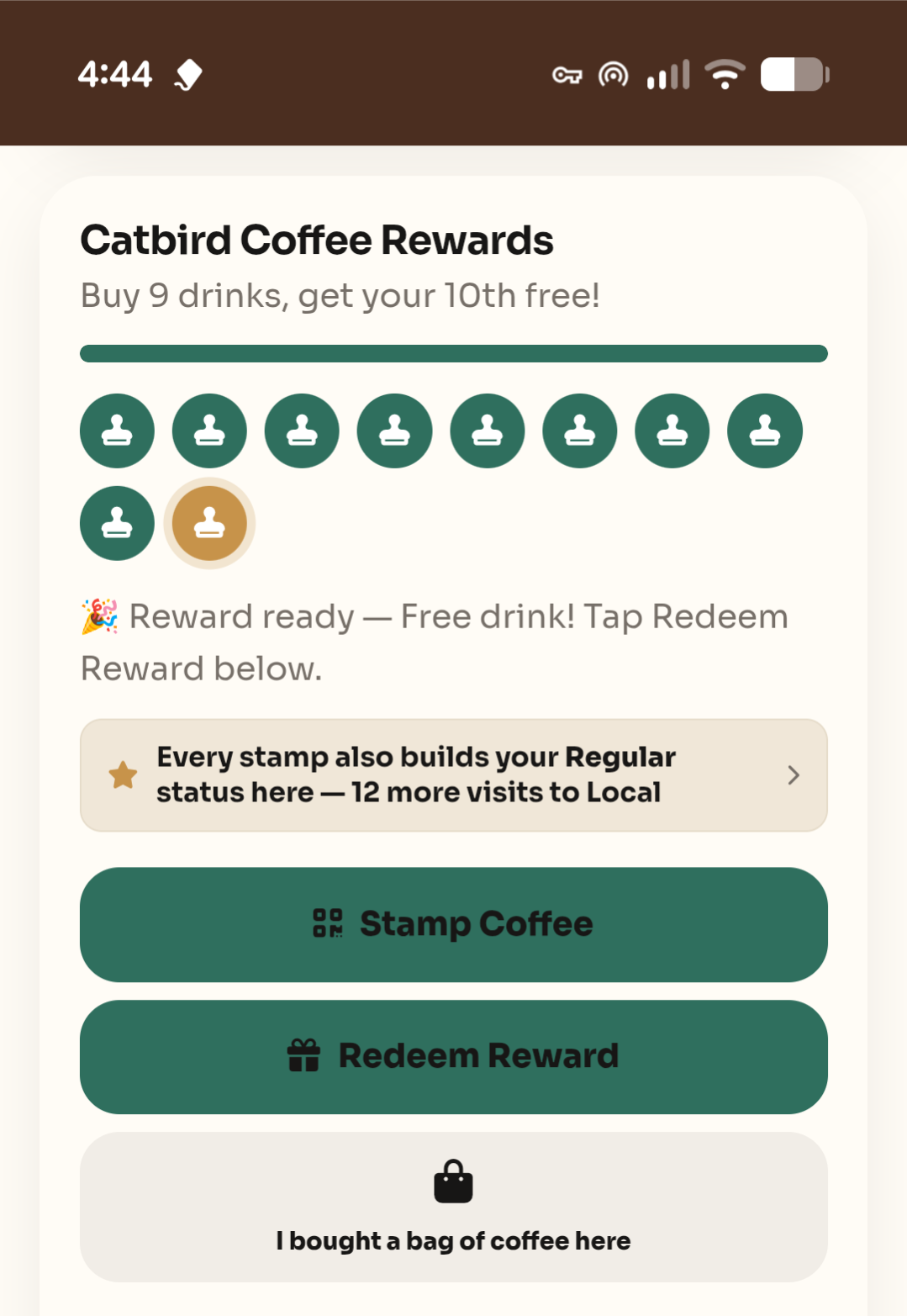 A shop's punch card screen with all stamps filled and a 'Reward ready — free drink!' message